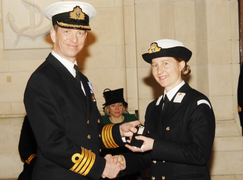 Mid Claire Rossiter receives her Midshipman 'rank slides' from the COCaptain Jerry Kyd of Britannia Royal Naval College